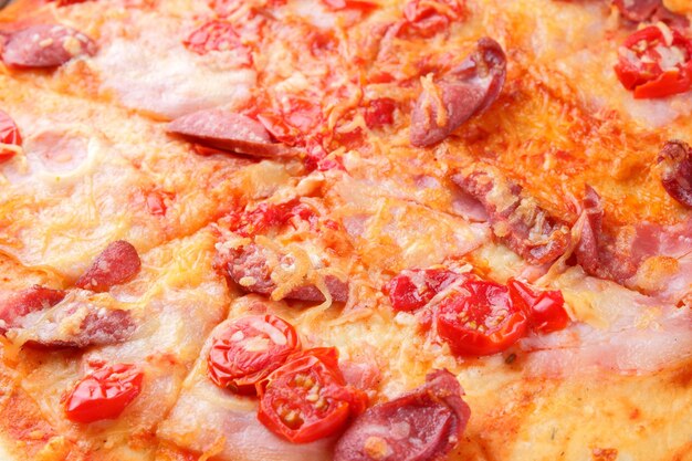 Pizza close up italian pizza with bacon tomatoes sausages and cheese italian cuisine