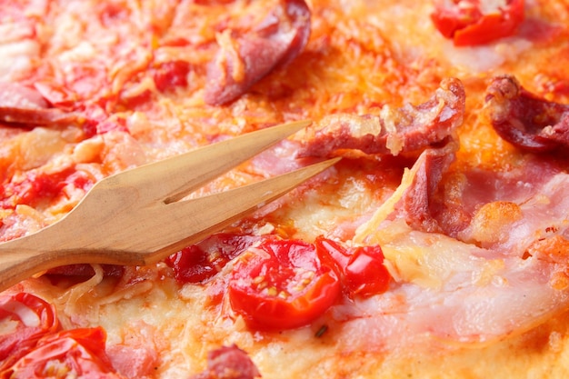 Pizza close up Italian pizza with bacon tomatoes sausages and cheese Italian cuisine