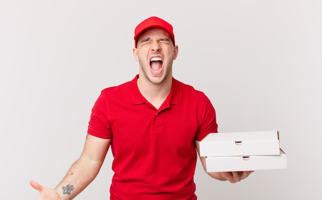 Pizza deliver man shouting aggressively, looking very angry, frustrated, outraged or annoyed, screaming no