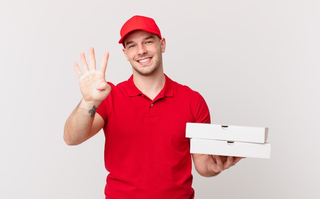 Pizza deliver man smiling and looking friendly, showing number four or fourth with hand forward, counting down