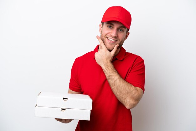 Pizza delivery caucasian man with work uniform picking up pizza boxes isolated on white background happy and smiling