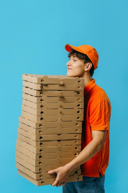 Pizza delivery concept Pizza delivery man with lots of pizza boxes Photo mockup