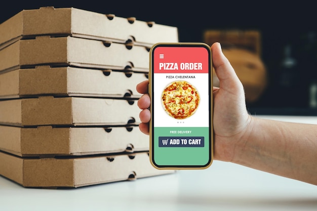 Photo pizza delivery and food app in phone online order restaurant take away lunch menu in cellphone screen with takeout box