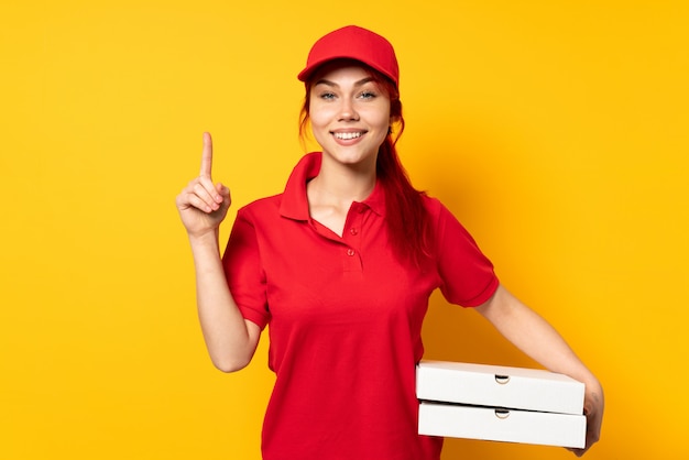 Pizza delivery girl holding a pizza over wall pointing up a great idea