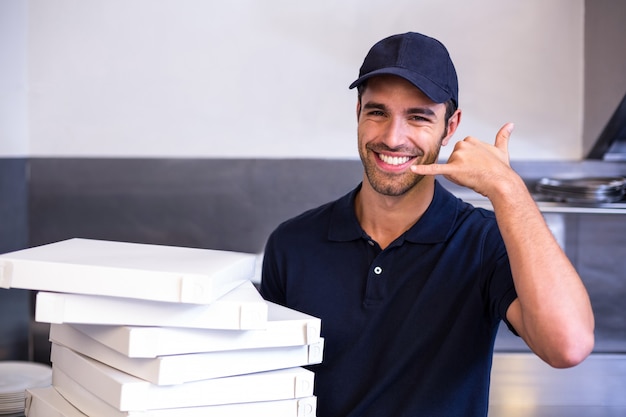 Pizza delivery man carrying boxes