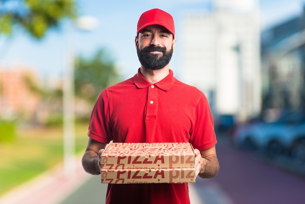 Uomo di consegna pizza su sfondo unfocused