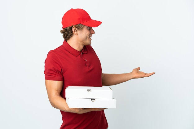 Pizza delivery man over white with surprise expression while looking side