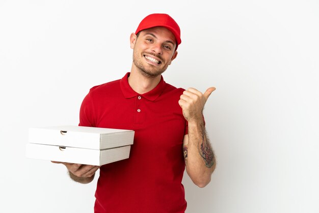 Pizza delivery man with work uniform picking up pizza boxes