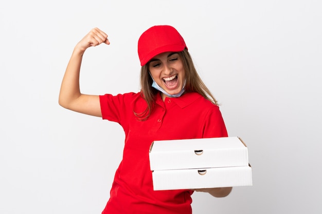 Pizza delivery woman holding a pizza and celebrating a victory