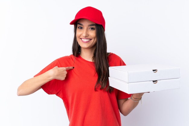 Pizza delivery woman holding a pizza over isolated white wall with surprise facial expression