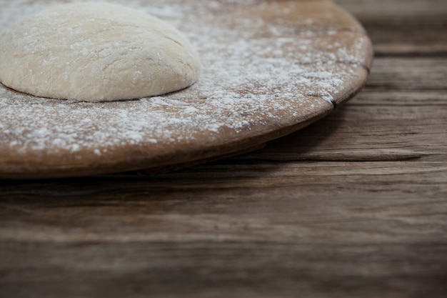 Pizza dough and flour on rolling board