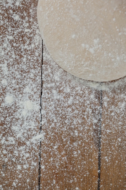 Pizza dough and flour on rolling board