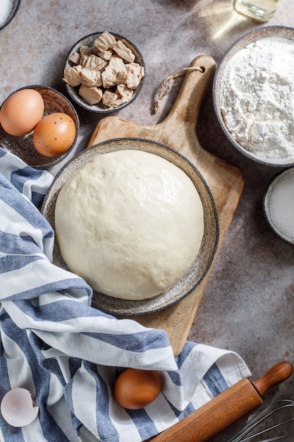 Pizza dough on rustic background Cooking time