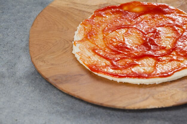 Pizza dough with tomato sauce