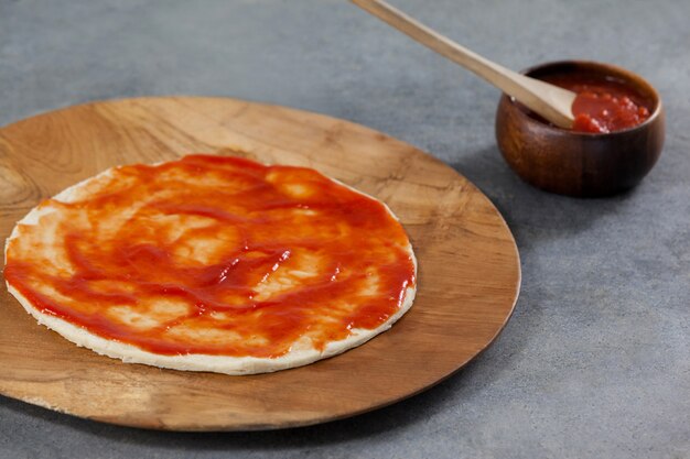 Pizza dough with tomato sauce