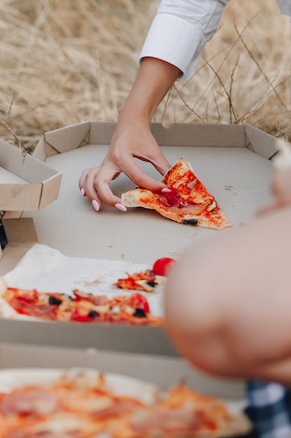 Pizza on the lawn in boxes