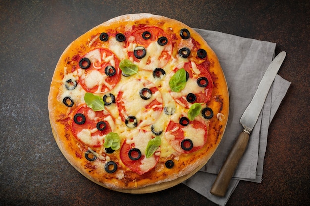 Pizza margarita with tomatoes and slices of olives