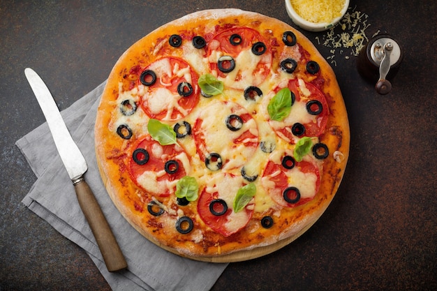 Pizza margarita with tomatoes and slices of olives