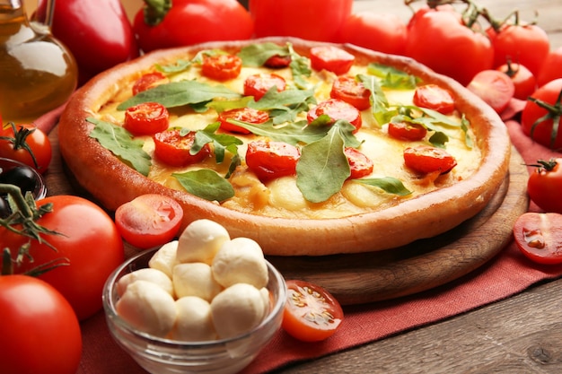 Pizza Margherita with arugula and vegetables closeup