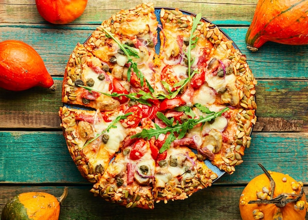 Pizza met salami, kaas, tomaat op een platbrood van pompoen. Herfst recept