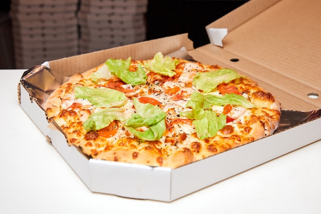 Pizza in an open box prepared for delivery