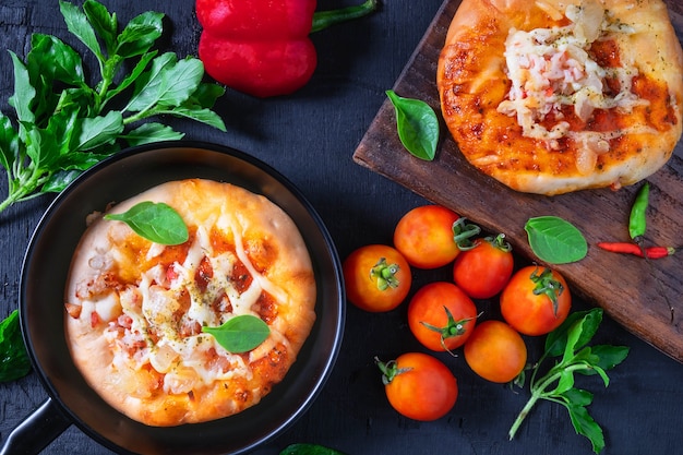 Pizza in a pan with pizza on a wooden tray