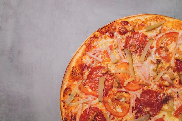 Pizza pepperoni, mozzarella, oregano on a black background.