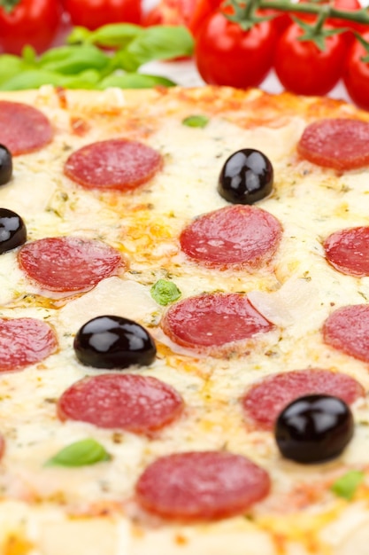 Pizza pepperoni salami baking ingredients close up portrait format on wooden board