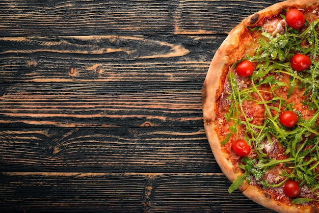 Pizza Primavera Cherry tomatoes arugula cheese On a wooden background Top view