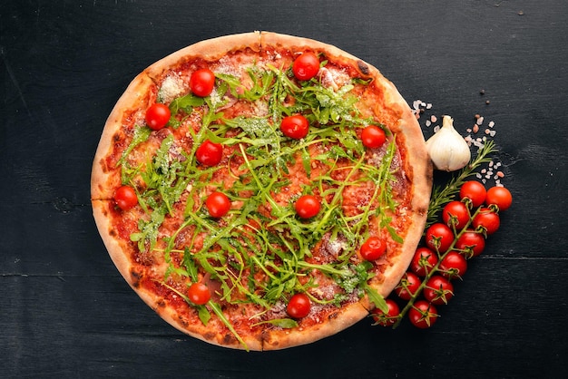Pizza Primavera Cherry tomatoes arugula cheese On a wooden background Top view