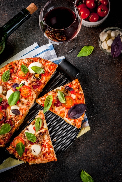 Pizza and red wine on dark background 