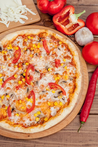 Pizza and red wine on wooden table background Top view with copy space