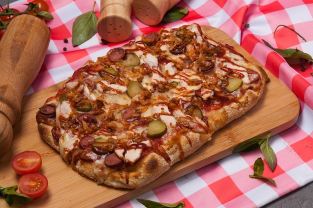 Pizza on Roman dough with Bavarian sausages chicken fillet and pickled cucumber