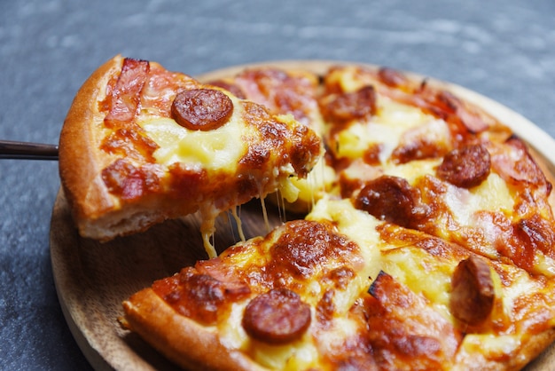 Pizza slice on dark background