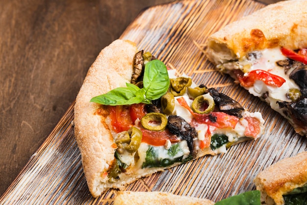 Pizza slices on cutting board high angle