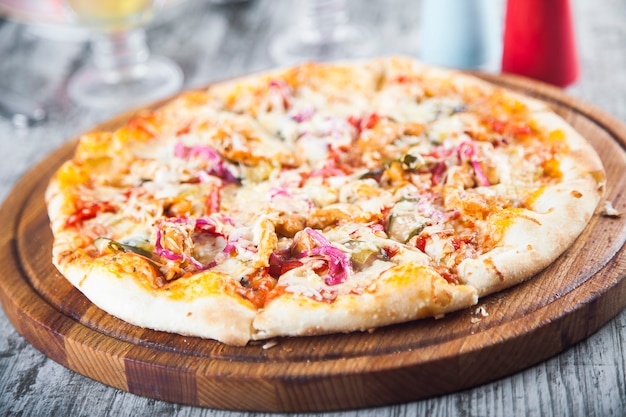 pizza stuffed with tomatoes and cheese on a wooden table