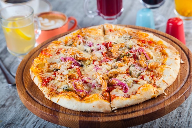 pizza stuffed with tomatoes and cheese on a wooden table