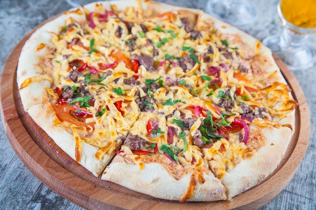 pizza stuffed with tomatoes and cheese on a wooden table