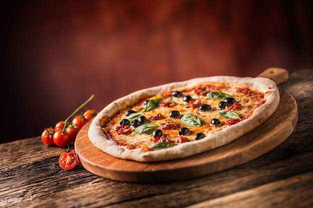 Pizza. Tasty fresh italian pizza served on old wooden table.