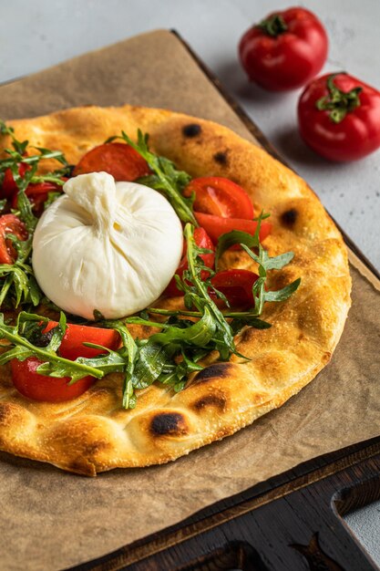 Pizza and tomato on a grey background Fresh Homemade Italian Pizza Italian food delicious