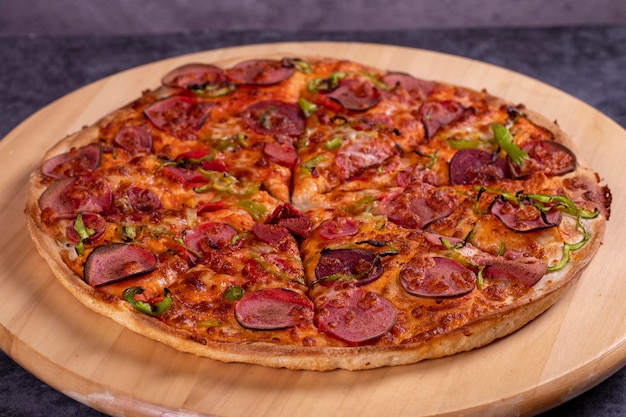 Photo pizza traditional italian cuisine delicacies pizza with sausage on dark background