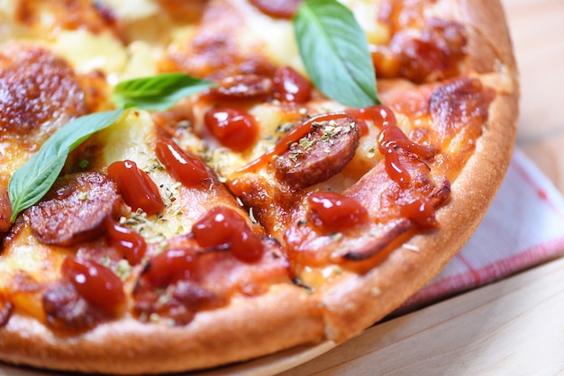 Pizza on tray and ketchup basil leaf top view 