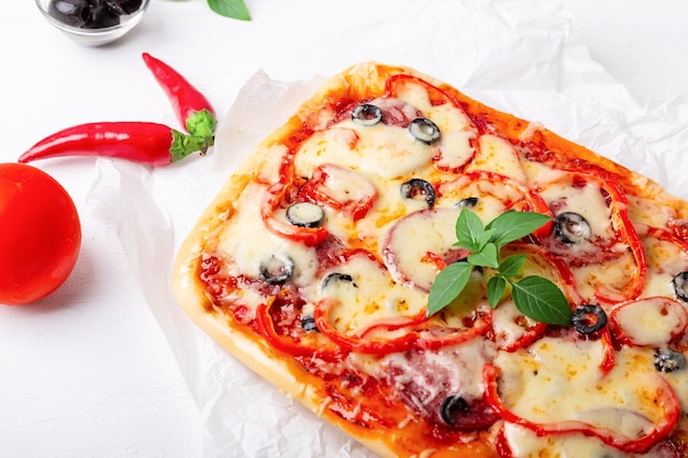 Pizza and vegetables on a light background