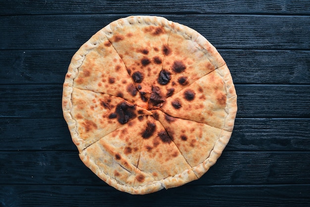 Pizza Volcano Gorgonzola cheese cherry tomatoes fresh vegetables and spices On a wooden background Free space for your text Top view