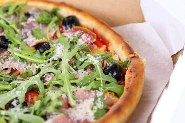 Pizza with arugula closeup