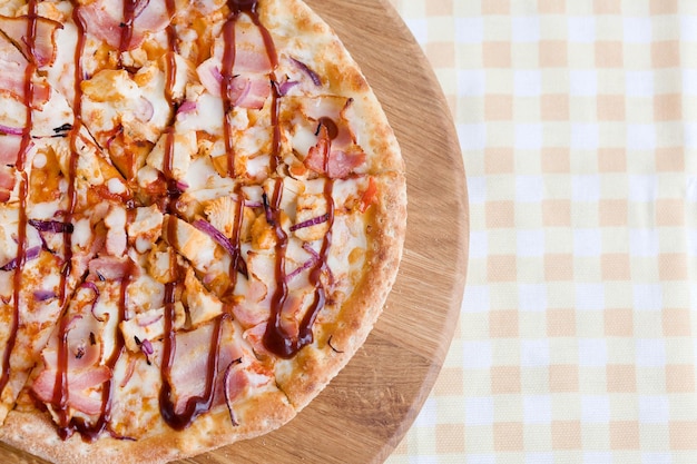 Photo pizza with bacon and tomato sauce from a woodburning oven food photography top view