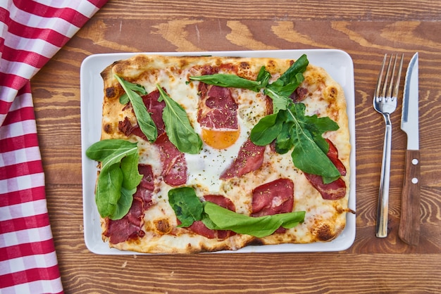 Pizza with Bacon on Wooden Table