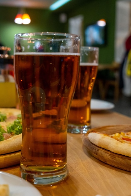 Pizza with beer close up at cafe table