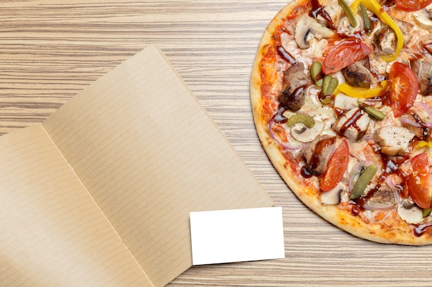 Pizza with blank paper with copy space