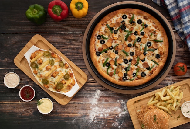 Pizza with Burger, Cheese fries on wooden table, top view